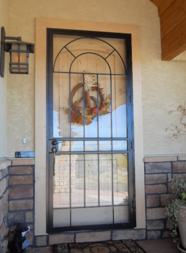 A custom steel security door blends in with the front of a home