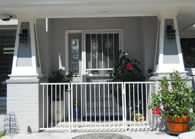 A steel gate secures a front porch